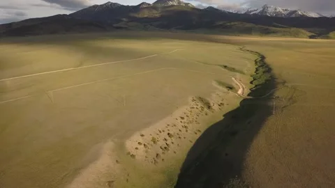 Vast greed field with distant mountain peak Stock Footage 166257548