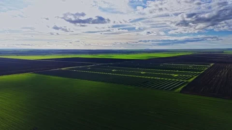 Vast green fields with contrasts of clouds and land from above Stock Footage 325087172