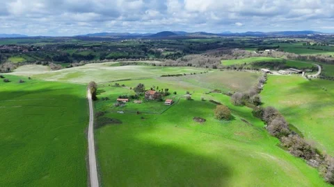 Vast Green Fields Stretching Under a Dramatic Sky in Rural Countryside Stock Footage 281329740