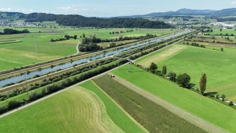 Vast green fields, waterways, and a road stretching into the distance, Stock Footage 284307630