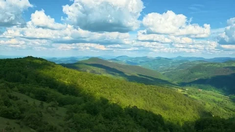 Vast green hills roll under bright blue sky. Zlatibor Mountain, Serbia. Video stock 337123250