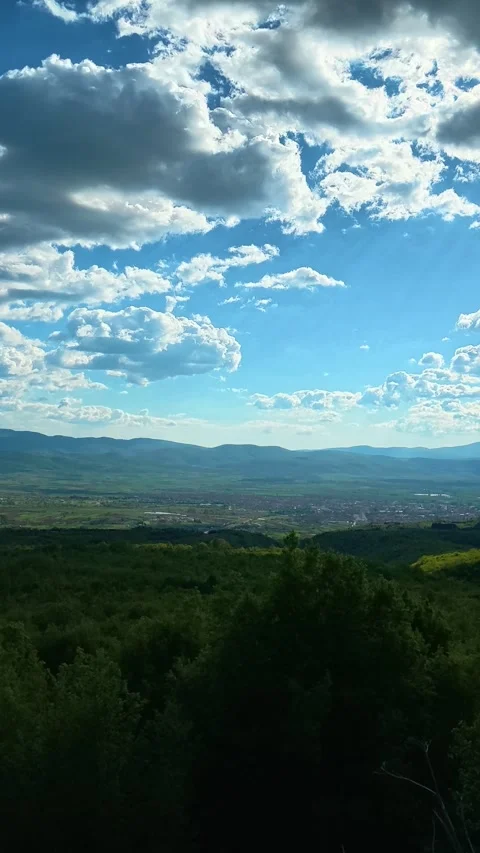 Vast green hills stretch beneath a bright blue sky. Pirot panorama, Vertical Vídeos de archivo 335947657