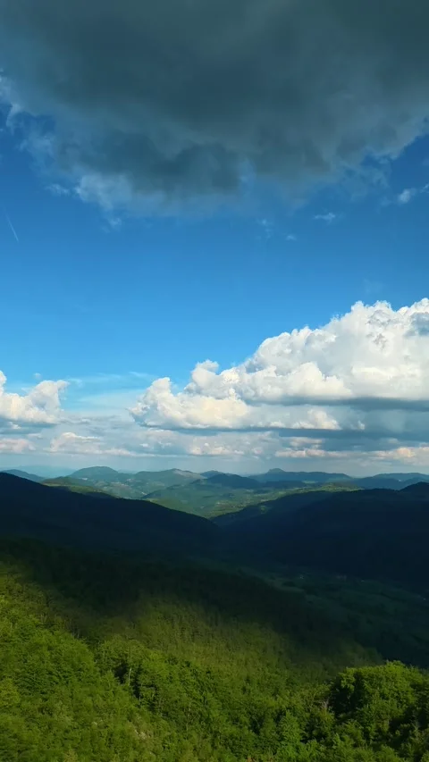 Vast green mountains stretch beneath a dramatic sky. Zlatibor, Serbia. Vertical Stock Footage 337482968