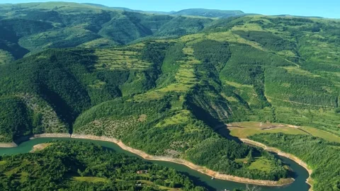 Vast green valley with winding river below. Kozji Kamen viewpoint, Serbia Stockbeeldmateriaal 342340969