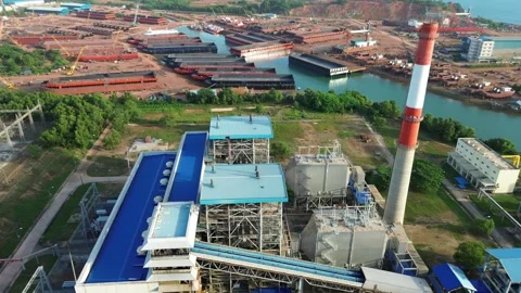 Vast industrial power generation facility with a towering stack juxtaposed .. Stock-Footage 325285964