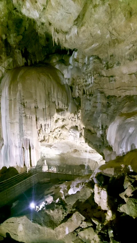 Vast interior of the New Athos Cave in Abkhazia featuring dramatic stalactite  Stock Footage 344945860