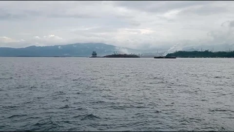 The vast ocean with a backdrop of ship shadows and cloudy mountains Stock Footage 277260115