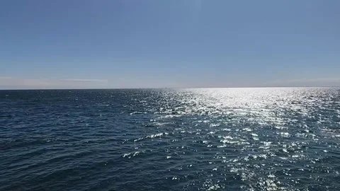 Vast ocean waves ripple under bright sunlight in steady motion video clip Stock Footage 344369117