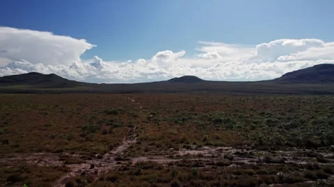 Vast open field and distant hills on a sunny day with blue sky Stock Footage 332725242