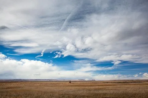 Vast Open Landscape With Expansive Sky And Rolling Clouds Stock Photos