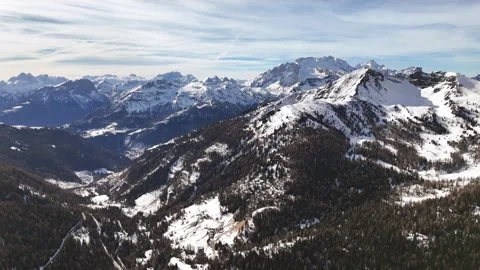 Vast panoramic view of the Dolomites covered with snow and the valley beneath Stock Footage 271148740