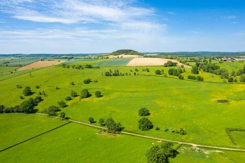 Vast patchwork fields with distant wooded hill 스톡 사진