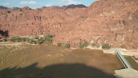 Vast Red Rock Formations and a Dam in the Saudi Arabian Desert Stock Footage 320822959