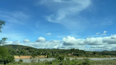 Vast rural fields and low hills stretch beneath bright clouds, filmed in slow 動画素材 329680267