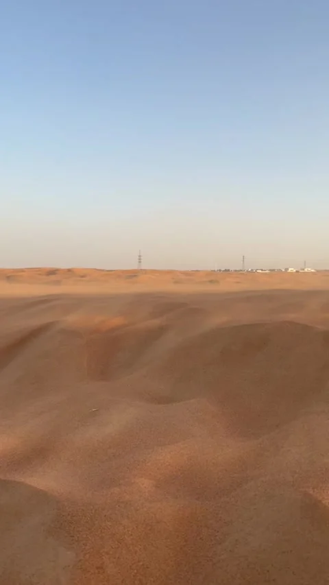 Vast sand dunes extending across desert landscape under clear sky. Stock Footage 343681032