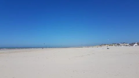 Vast Sandy Beach Under Clear Blue Sky Stock Photos