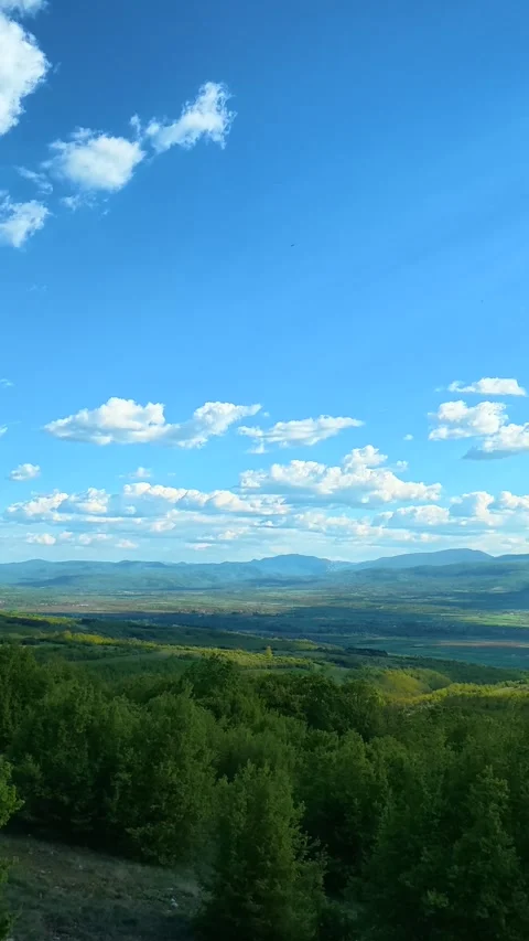 Vast sky holds fluffy white clouds. Pirot city panorama, Vertical Video stock 335947654