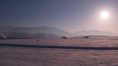 Vast snow covered fields, hazy sunny day, Turkey, jk01 Stock Footage 267012687