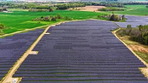 Vast Solar Array Spanning Across Lush Countryside Landscape Stock-Footage 335210288