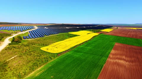 Vast solar farm surrounded by patchwork fields, Bulgaria Video stock 344691457