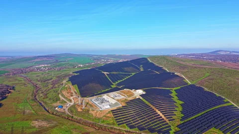 Vast solar panel array captures sunlight on a sunny day in the countryside, Stock Footage 331947013