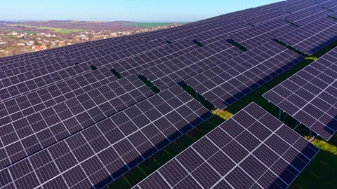 Vast solar panel array glistens under a clear sky while painting the landscape Stock Footage 331267968