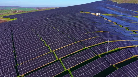 Vast solar panel array shining under clear blue skies in a rural landscape Stock Footage 331082875