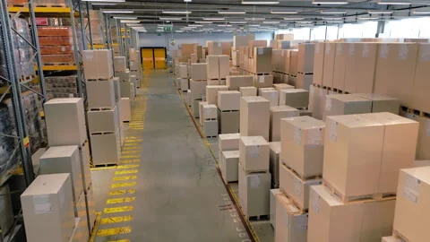 A vast warehouse with rows of boxes and shelves. Stock-Footage 307999679