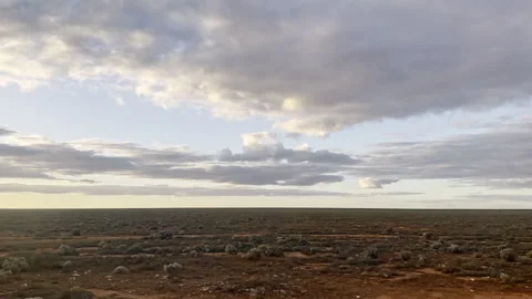Vasty red dirt of treeless Nullabor Plain flies past, viewed from speeding train Video stock 242839541