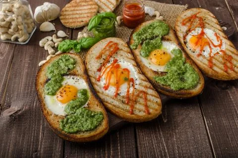 Vatiations of fried eggs inside bread Stock Photos