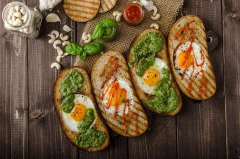 Vatiations of fried eggs inside bread Stock Photos