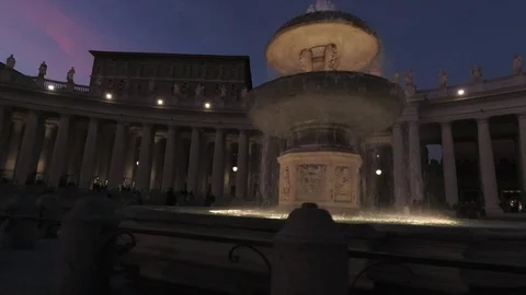 Vatican - Saint Peter square Pan view with the fountain and the dome at dusk Stock Footage 99359426