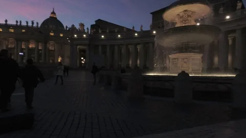 Vatican - Saint Peter square Pan view with the fountain and the dome at dusk Stock Footage 99359432