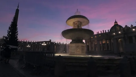 Vatican - Saint Peter square Pan view with the fountain and the dome at dusk Stock Footage 99359446