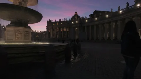Vatican - Saint Peter square Pan view with the fountain and the dome at dusk Stock Footage 99359450