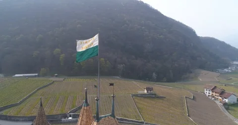 Vaud flag rotation on Aigle castle - Aerial 4K Stock Footage 106301809