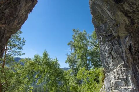 The vault of the cave is high in the mountains. warm summer day Stock Photos