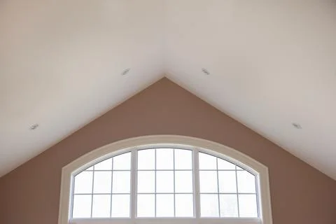 A vaulted ceiling and beautiful window Stock-Fotos