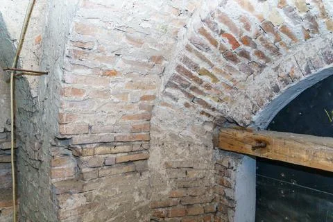 The vaulted ceilings in the old red brick building. An old dusty corridor in  Stock Photos