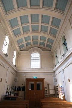 Vaulted Coffered Ceiling and High Windows of Church Interior Foto stock