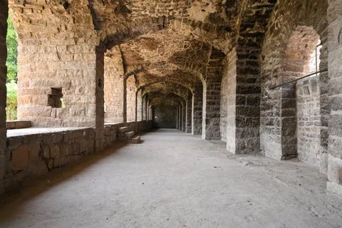 Vaulted Masonry Gallery with Repeating Stone Arch Columns Stock Photos