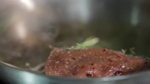 Veal steak in a hot pan Stock Footage 154204888