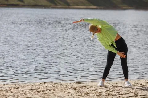 Veautiful self determied female runner in trendy sportswear posing isolated on Stock Photos