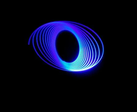 A vector blue neon light circle trail on a black background - great for a coo Stock Photos