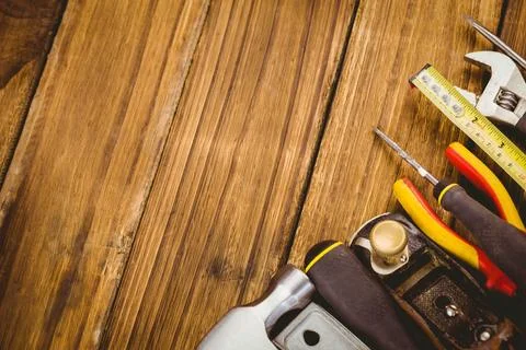 Vector flat lay is showing wrench tape and screwdrivers on wood grain copy space Stock Photos