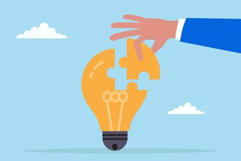 Vector illustration of a hand placing the final puzzle piece into a light bulb Stock Illustration