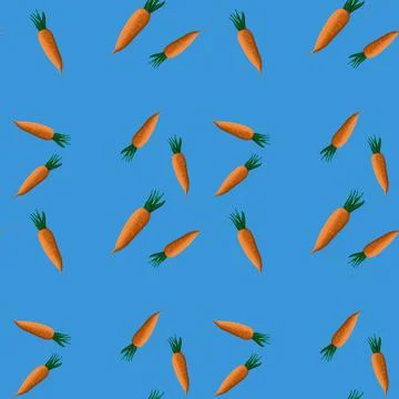 Vector seamless pattern with cute orange carrots on blue background Illustrazione stock
