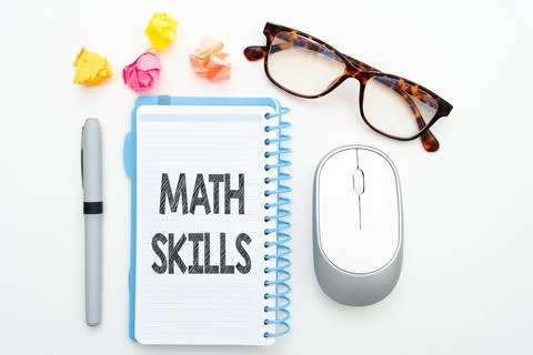 Vector of text 'Math Skills' on notebook near glasses and computer mouse in whit Stock Photos