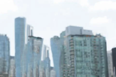 Vector waterfront skyline is featuring green glass tower among towers under Stock Photos