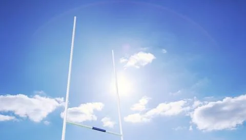 Vector white rugby goalposts are standing against blue sky, showcasing Foto stock